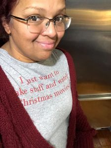 Mary Anne, wearing a t shirt that says I just want to bake and watch Christmas movies.